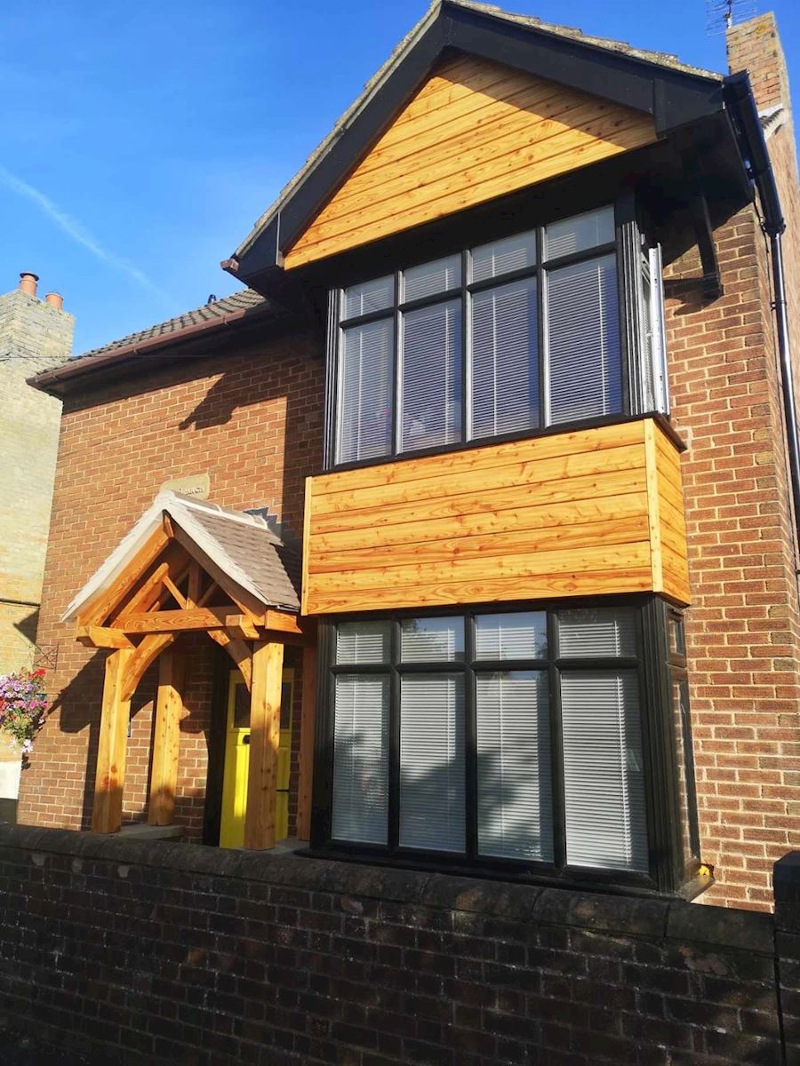 Black UPVC Bay With Wooden Cladding